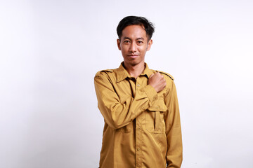 Confident indonesian civil servant standing with salute gesture. Isolated on white