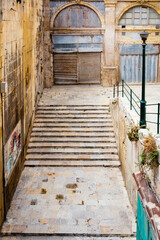 Mediterranean weathered house front with colourful windows and doors