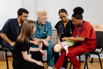 Medical Students Practicing CPR on a Baby Mannequin