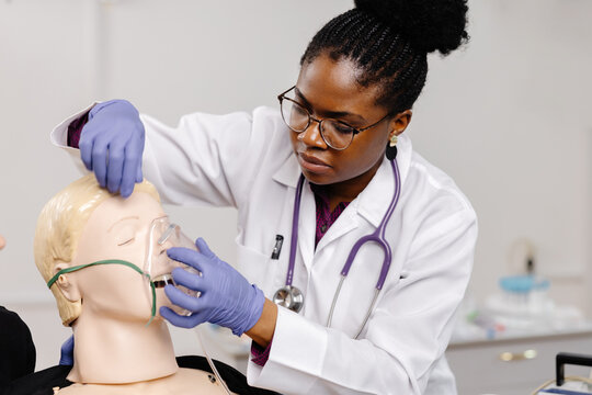 Medical Professional Practicing Oxygen Mask Application on a Mannequin