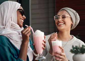 Muslim women, milkshake and happy in restaurant with conversation, bonding or reunion with drinks....