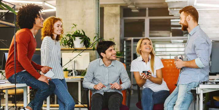A group of individuals are seated in a circular formation, facing each other. They appear engaged in conversation or a discussion, with some gesturing or listening intently, sharing business ideas