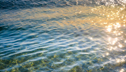 water waves of the sea and ocean with glare and rays of the sun, summer wallpaper for the presentation of recreation and vacation