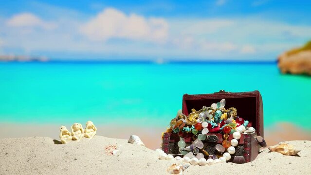 Copyspace. Relax, adventure, rich tropical sea resort. Beautiful shell and chest with jewelry on sand. Beautiful sea coast beach. Azure water on ocean, sea coast resort. Summer holidays. Blue sky