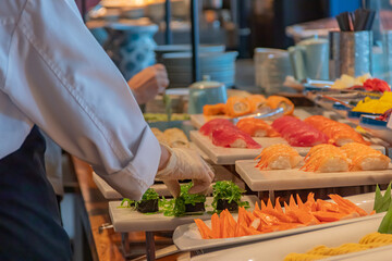 Hand of chef take arranging food buffet japan food in hotel party, Food and drink