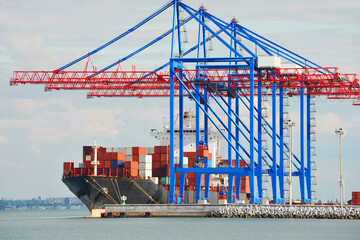 Container ship under port crane