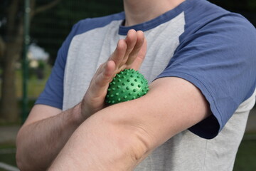 A young man in sportswear engages in a workout, using a sport tool for physical exercises on a...