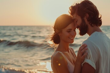 Fototapeta premium A couple embraces on a sandy beach at sunset