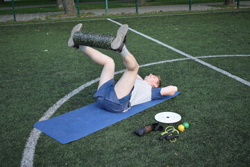 A young man in sportswear engages in a workout, using a sport tool for physical exercises on a...