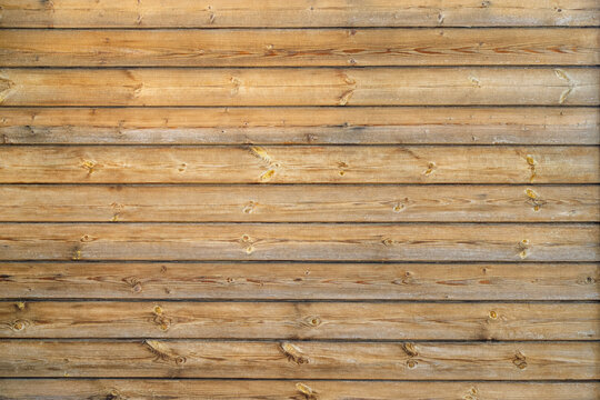 Texture of an old cracked wall made of wooden panels as a rustic natural background