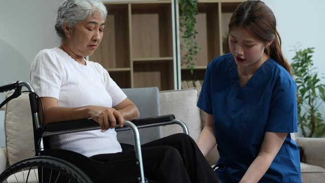 senior woman doing exercise at clinic with physiotherapist. help of a personal trainer during a rehabilitation session.