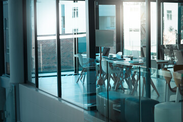 Empty room, table and chair for modern conference, corporate and meeting boardroom in building. Vacant, furniture and seats for luxury office or workplace, interior and minimalist design with glass