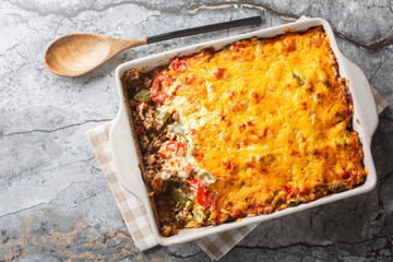 John Wayne Casserole is a delicious and filling layered casserole with taco meat, buttery biscuits,...