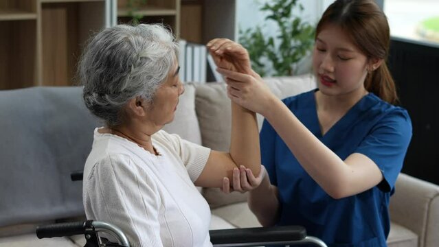 senior woman doing exercise at clinic with physiotherapist. help of a personal trainer during a rehabilitation session.