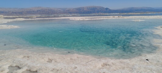 Fototapeta premium The insanely beautiful Dead Sea resort. March 2024. Reflection of the sky in the sea