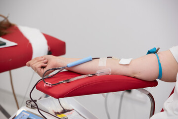 view of donor giving blood at donation center