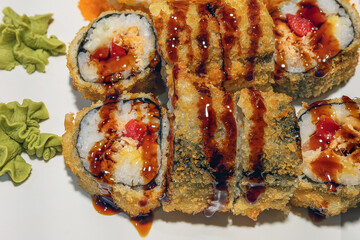 Salmon and other fish sushi rolls on a tray