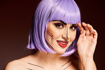 A woman with purple hair and vibrant pop art makeup strikes a confident pose