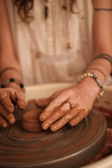 Female potter making ceramic jug with her fingers