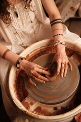 Female potter making ceramic jug with her fingers