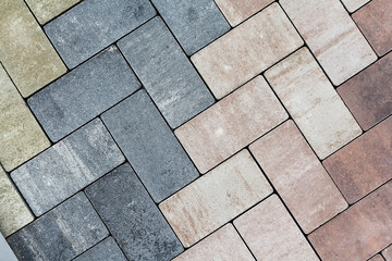 Multicolored paving slabs for road paving by mosaic on shop window