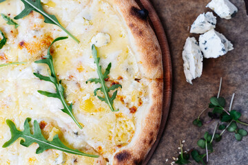 Rustic pizza presentation with fresh arugula and artisanal cheese