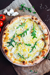 A freshly baked pizza with a golden, crispy crust served on a wooden board