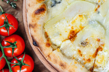 A close-up view of a cheesy pizza with a unique topping of pear slices, perfect for a gourmet meal