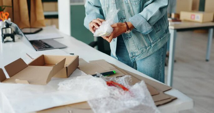 Hands, boxes and packaging for shipping at startup, warehouse and bubble wrap with safety for delivery. Person, plastic and cardboard for storage, supply chain and cargo for distribution in factory