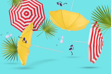 Summer party. Beach umbrellas, sunglasses and palm leaves in air on light blue background