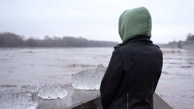 A girl watches an ice drift on the embankment on the Belaya River in Ufa.