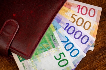 Norway money, Norwegian kroner sticking out of the wallet, financial business concept