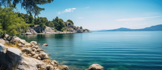 Obraz premium View of the blue lake from the rocky shore. Creative banner. Copyspace image