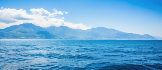 Panoramic views of the blue sky and mountains above the ocean. Creative banner. Copyspace image