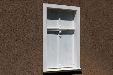 Single old white window in the wall