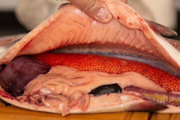 Butchering trout, fresh fish with caviar