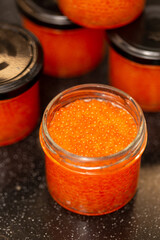 Jars of red caviar, freshly salted caviar at home