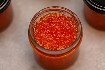 Jars of red caviar, freshly salted caviar at home