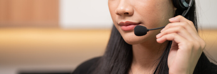 Closeup Asian woman call center, customer service, telesales wearing headset or headphone talking...