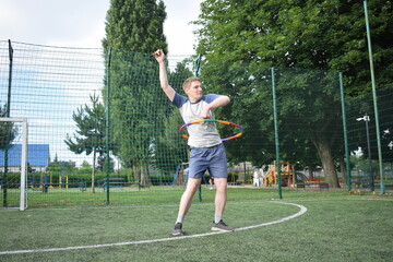 A young man in sportswear engages in a workout, using a sport tool for physical exercises on a...