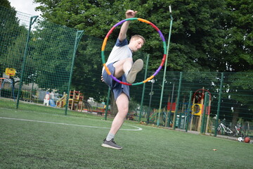 A young man in sportswear engages in a workout, using a sport tool for physical exercises on a...