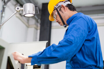 Fototapeta premium experienced operator technician worker or engineer metalworker industrial in safety helmet working or repair on metal machine, professional maintenance skill man in industry manufacturing. men at work