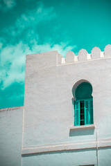 Traditional blue Tunisian metal door with a pattern in a white building in the city of Sidi Bou Said in Tunisia in the summer on a sunny day