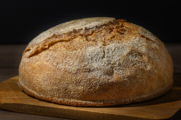 Loaf of bread in bread tin on kitchen table