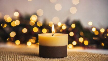 Handmade soy candle and blurred Christmas garland. Merry Christmas and Happy New Year