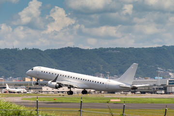 Obraz premium airplanes jet take off from runway on taxi lane in airport and aircraft traffic to take off with cityscape background, view from window air plane.