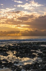 Scenic view of golden sunset over a rocky shoreline