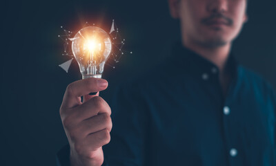 Idea innovation and inspiration concept.Hand of man holding illuminated light bulb, Idea innovation and inspiration concept.  creativity with bulbs that shine glitter, Concept for success.