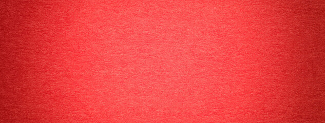 Texture of vintage red paper gradient background with dark vignette. Structure of craft cardboard with frame.