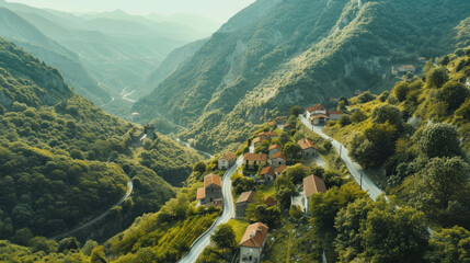 Aerial shot of a picturesque village road winding through hills